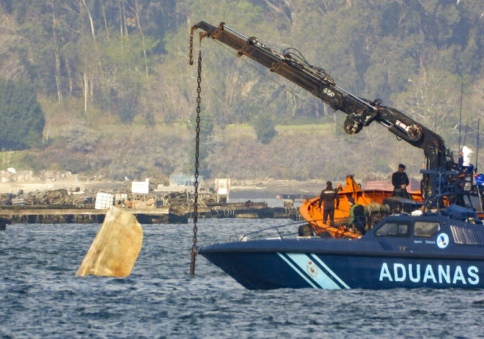 Spanish authorities inspect a sunken submarine off northweastern Spanish coast